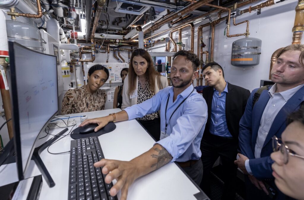 Hudson Clean Heat team reviewing clean heating system data in a mechanical room